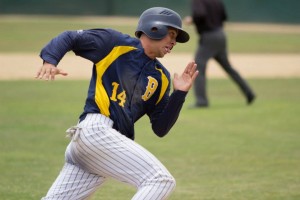 Blues outfielder __ rounds third base during the Blues' victory over Long Beach on Sunday. By Owen Main