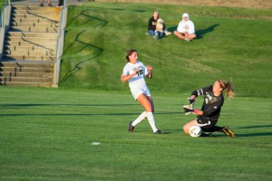Sarah Lancaster scoots the first Cal Poly goal of 2013 past the LMU keeper on Friday night. By Owen Main