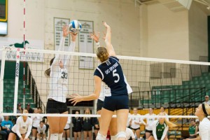 Maddie Kuber usually runs the offense, but here she gets a deflection on an attack from Irvine's Aly Squires. By Owen Main