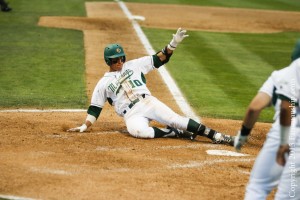 Cal Poly's Nick Torres slides into home safely after a bases-loaded single turned into a three-run error. By Owen Main