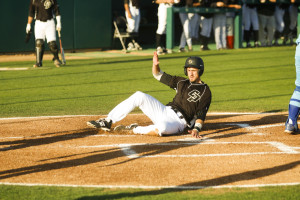 Zack Zehner slides home safely in Cal Poly's three-run first inning. By Owen Main