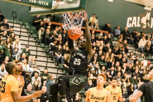 Cal Poly senior Joel Awich throws down a dunk in the first half of Saturday night's thriller. By Owen Main